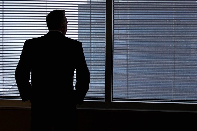 Businessman looking out office window